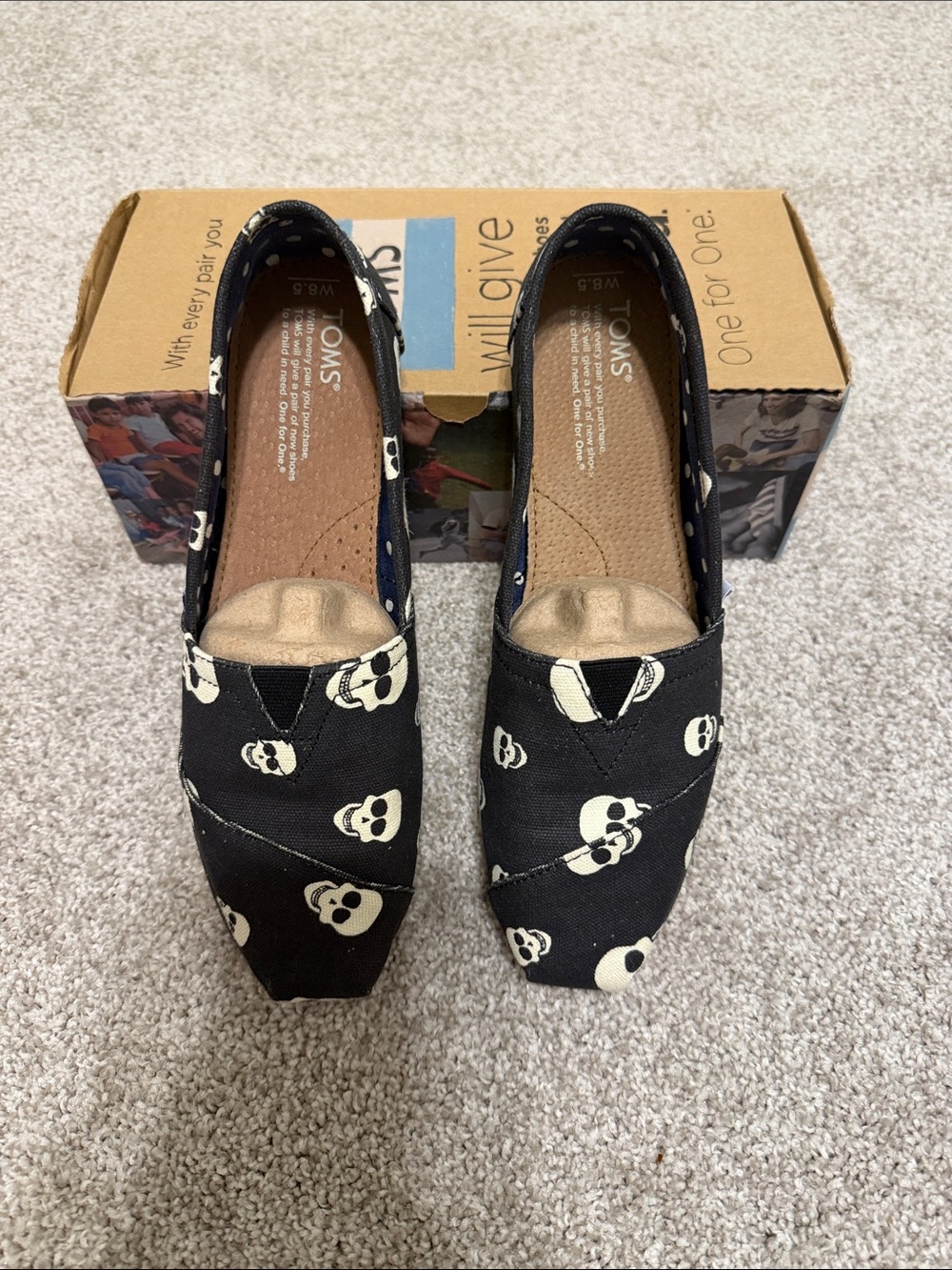 Toms Black Canvas Slip-On Flats with Ivory Skull Print
